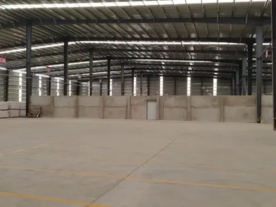 Interior of a completed steel-framed warehouse with a concrete floor